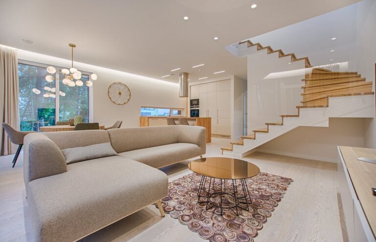 Modern living room with staircase and sofa
